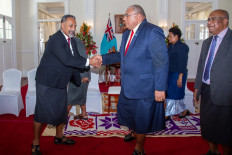 Fiji's President Ratu Wiliame Katonivere (center) shakes hands with Sakiasi Ditoka, Minister for Rural, Maritime, Development and Disaster Management during an oath taking ceremony of the newly elected government in the capital city Suva on December 24, 2022.