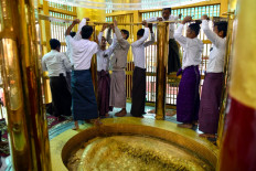 This picture taken on January 25, 2023 shows members of trustees preparing to open the footprint of buddha during the Mann Shwe Sat Thaw Pagoda Festival at Min Bu township in Magway Region.