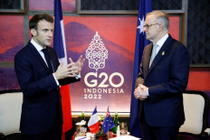 France's President Emmanuel Macron (left) meets Australia's Prime Minister Anthony Albanese on the sidelines of the G20 Summit in Nusa Dua in Bali on November 16, 2022. 
