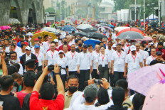 President Joko “Jokowi” Widodo (center, wearing black baseball cap) leads his entourage, which included several Cabinet ministers, in a march to a stage installed at the Hotel Indonesia traffic circle in Jakarta on Jan. 29, 2023. The President hosted an event on Sunday to kick off Indonesia’s 2023 ASEAN chairmanship, expressing his optimism in his opening speech that, under Indonesia's leadership, ASEAN will continue to grow and make a major contribution to the region and the world