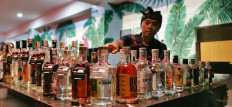 A man organizes bottles of premium arak at the Arak Bali Day celebration in Nusa Dua, Bali, on Jan. 29.