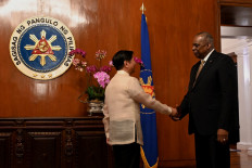 Philippine President Ferdinand Marcos Jr (left) receives US Secretary of Defence Lloyd Austin prior to a meeting at the Malacanang Palace in Manila on February 2, 2023. 
