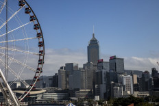 An observation wheel is seen in front of the Hong Kong skyline in the central district of Hong Kong, China, on Feb. 2, 2023.