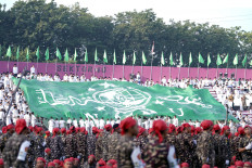 A giant flag bearing the logo of Nahdlatul Ulama is unfurled in the stands at Gelora Delta Stadium in the East Java city of Sidoarjo on Feb. 2, 2023, when the country’s largest Muslim organization held its 1st Century NU Celebration Reception.