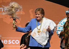 Former German Chancellor Angela Merkel gestures after receiving the Felix Houphouet-Boigny Peace Prize at the Felix Houphouet-Boigny Foundation in Yamoussoukro on February 8, 2023.