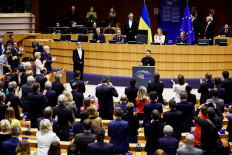 Ukrainian President Volodymyr Zelensky (center) delivers a speech at the start of a summit on Feb. 9, 2023 at the European Parliament in Brussels. 