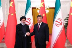 This handout picture provided by the Iranian presidency shows Chinese President Xi Jinping welcoming the Islamic Republic's President Ebrahim Raisi (left) during his visit in Beijing on February 14, 2023. 
