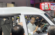 President Joko “Jokowi“ Widodo sits behind the wheel of an Esemka car prototype at the Indonesia International Motor Show in Central Jakarta on Feb. 16.