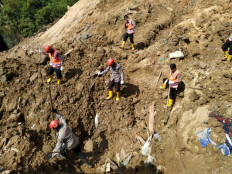 Rescuers search for survivors after a landslide sparked by rain killed at least nine in South Tapanuli, North Sumatra, on May 4, 2021.