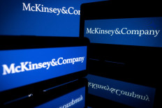 This file photo taken on April 12, 2022 in Toulouse shows screens displaying the logo of US-based McKinsey & Company management consulting firm. Four judicial searches perquisitions were caried out at the end of January at the home of managers and former managers of McKinsey in connection with an investigation over suspected illegal fundings in the presidential campaigns of Emmanuel Macron, according to sources close to the case on February 17, 2023.
