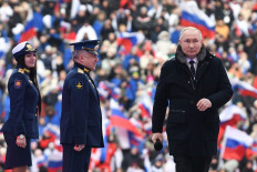 Russian President Vladimir Putin attends a patriotic concert dedicated to the upcoming Defender of the Fatherland Day at the Luzhniki stadium in Moscow on Feb. 22, 2023.