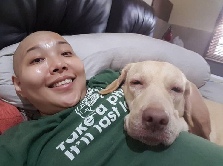 Special supporter: Patricia Bunadi, 42, who has Stage 3 ovarian cancer, depends on support from her Labrador, Whitney, the successor to Louwey, also a Labrador, with whom she had a close relationship. (Courtesy of Patricia Bunadi)