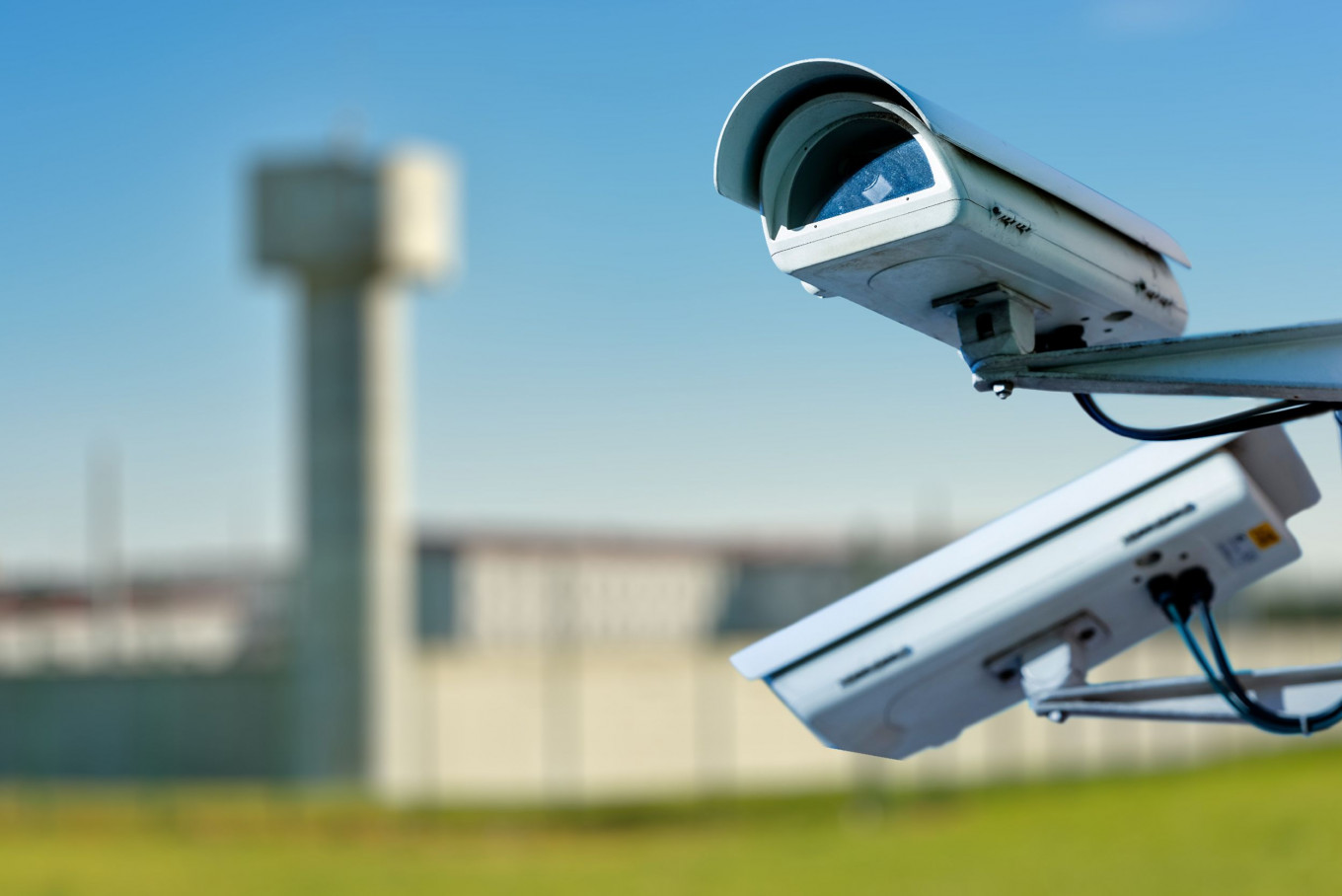 An illustration of security CCTV camera or surveillance system within a prison compound. 