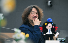 In this photo taken on January 9, 2023, 'News Factory' talk show host Kim Ou-joon speaks during an interview with AFP at a studio in Seoul.