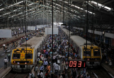 Commuters disembark from suburban trains at Churchgate railway station in Mumbai, India, on Feb. 1, 2023.
