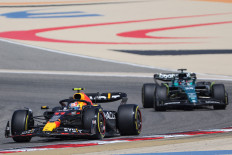 Red Bull’s Mexican driver Sergio Perez (front) drives ahead of Aston Martin’s Brazilian driver Felipe Drugovich during the third day of Formula One preseason testing at the Bahrain International Circuit in Sakhir, Bahrain, on Feb. 25, 2023.
