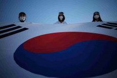 Children hold a giant national flag during a re-enactment of the March First Independence Movement against Japanese colonial rule in Cheonan, South Korea, Feb. 28, 2023.  