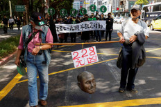 Activists hold the head of Chiang Kai-shek, then the president of the Republic of China, fled with his Nationalist forces to the island of Taiwan in 1949 after losing a civil war and ruled Taiwan by imposing Martial law  while march for the 76th anniversary of a violently suppressed anti-government uprising known as the 228 incident in Taipei, Taiwan, Feb. 28, 2023. 