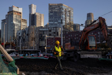 A worker walks across a construction site in the Central Business District of Beijing on Feb. 28, 2023, ahead of the opening of the National People's Congress.
