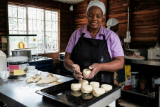 Veronica Makonese, a cook at Bottom Drawer, an upscale tearoom in Harare, uses a scone cutter to shape scone dough made from simple ingredients of flour, salt, yeast, sugar and milk, in Harare on February 16, 2023.