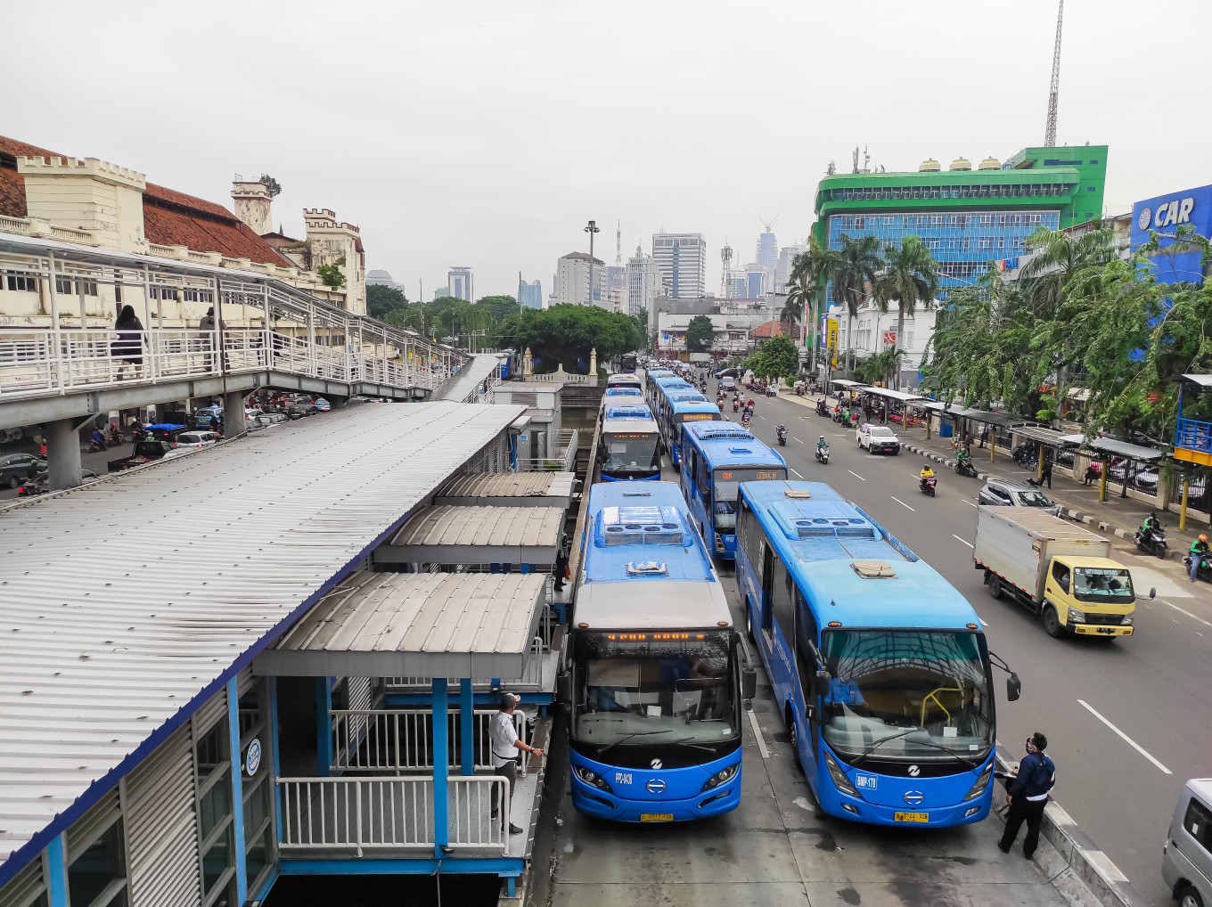 Transjakarta buses pick up passengers at the Harmoni bus stop in Central Jakarta on June 14, 2021. 