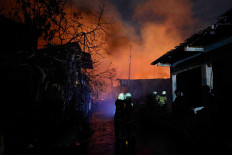 Firefighters try to extinguish a fire at a fuel storage station operated by Indonesia's state energy company Pertamina, in Jakarta, March 3, 2023. 