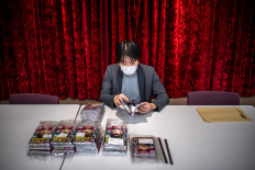 This picture taken on March 2, 2023 shows the acting chief Masakado Kunisawa checking copies of “Cyberpunk: Peach John“, Japan's first fully AI-drawn manga, at the office of comic book publisher Shinchosha in Tokyo. The author of a sci-fi manga about to hit shelves in Japan admits he has “absolutely zero“ drawing talent, so turned to artificial intelligence to create the dystopian saga.
All the futuristic contraptions and creatures in “Cyberpunk: Peach John“ were intricately rendered by Midjourney, a viral AI tool that has sent the art world into a spin, along with others such as Stable Diffusion and DALL-E 2.
