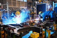 Employees work at an assembly line of a Wuling Motors factory in Qingdao in China's eastern Shandong province on March 1, 2023.
