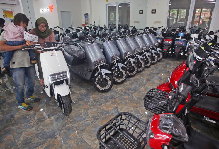 A consumer inspects an electric motorcycle showcased in the Tangkas Ciater electric motorcycle showroom in South Tangerang, Banten, on March 6, 2023.
