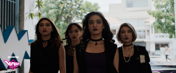 Rivalry: The girls of Scorpion Sisters, a famous rock band in 'Virgo and the Sparklings' fronted by Carmine (center), enter the same studio which Riani and her friends have just used. (Courtesy of Screenplay Bumilangit)