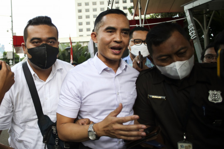 Former Yogyakarta Customs and Excise Office head Eko Darmanto (right) leaves the Corruption Eradication Commission (KPK) on March 7, 2023, after attending questioning regarding his net worth of Rp 15.7 billion (US$1 million).