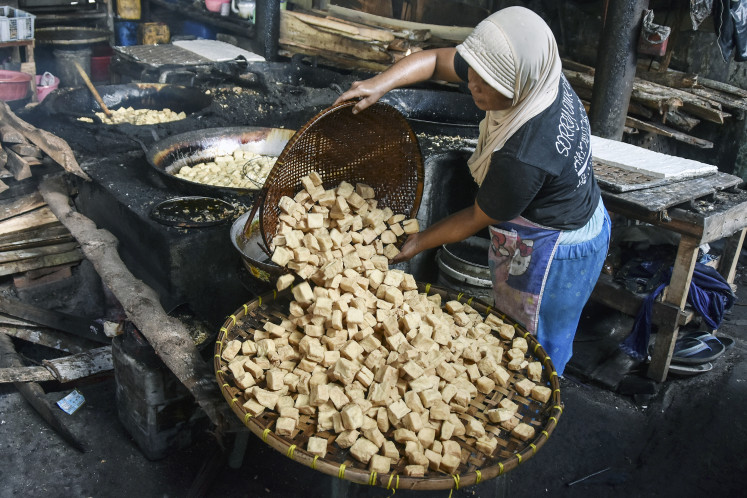 A worker fries tofu in Cisadap, Ciamis, West Java, on March 7, 2023. 
