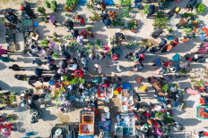 An aerial view shows people visiting a market in Ningbo, in China's eastern Zhejiang province on March 3, 2023.