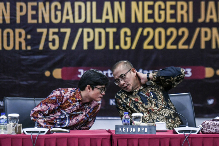 General Elections Commission (KPU) chair Hasyim Asy'ari (right) talks with commissioner August Mellaz during a group discussion in Jakarta on March 9 about a controversial order from the Central Jakarta District Court to postpone next year’s elections by 28 months, as a lawsuit filed by the fledgling Prima Party had demanded. 