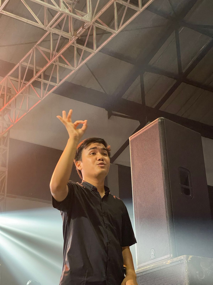 Expression matters: Facial expression is crucial for conveying a song's meaning to the crowd during a live performance, according to sign-language interpreter Rezki Achyana. (Courtesy of Rezki Achyana)