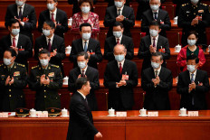 Chinese President Xi Jinping is applauded as he arrives for the fourth plenary session of the National People's Congress (NPC) at the Great Hall of the People in Beijing on March 11.     GREG BAKER/Pool via REUTERS