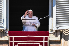 Pope Francis waves from the window of the apostolic palace during the weekly Angelus prayer on March 12, 2023 in The Vatican.