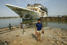 This file photo taken on May 13, 2003 shows Iraqi children in front of Iraqi dictator Saddam Hussein's luxury yacht the al-Mansur moored in Basra after it was bombed during the US-led invasion of Iraq.
