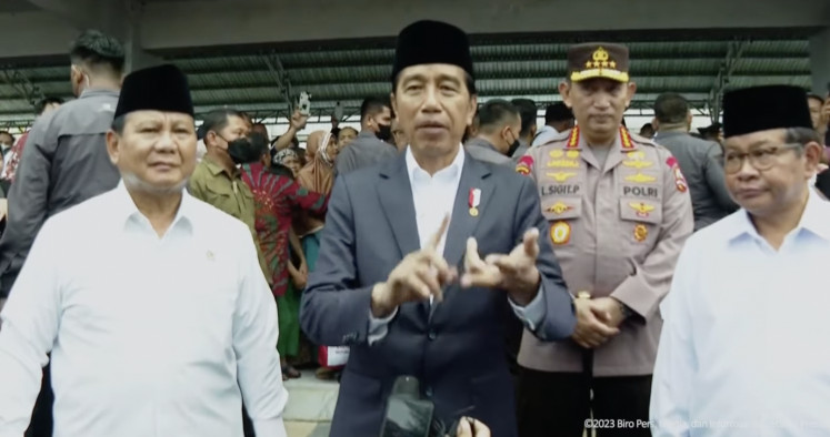 Defense Minister Prabowo Subianto looks on as President Joko “Jokowi“ Widodo delivers a press statement during a visit to South Kalimantan on March 16, 2023.