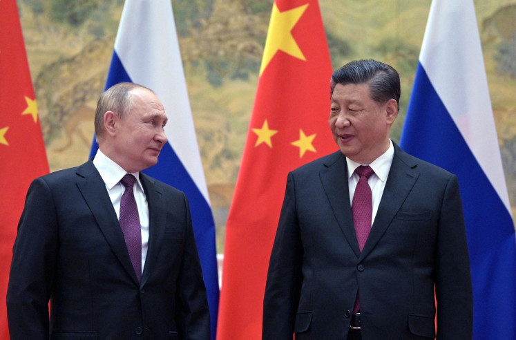 In this file photo taken on February 4, 2022, Russian President Vladimir Putin (left) and Chinese President Xi Jinping pose for a photograph during their meeting in Beijing.
