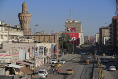 Vehicles drive along a street in Baghdad on March 19, 2023. It is more than 20 years since the start of the United States-led invasion of Iraq that toppled dictator Saddam Hussein. The oil-rich country remains traumatized from the years of war, occupation and bloody sectarian turmoil that followed the operation launched early on March 20, 2003.