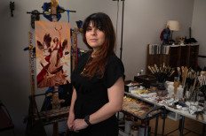 Illustrator and content artist Karla Ortiz poses in her studio in San Francisco, California, on March 8, 2023. Ortiz and two other artists have filed a class-action lawsuit against companies with art-generating services.
