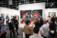 In this file photo taken on March 21, 2023, people visit Art Basel in Hong Kong. As thousands of visitors streamed through a Hong Kong exhibition hall and deals were struck for works by Picasso and Yayoi Kusama, art collectors celebrated the Asian financial hub's return to its bustling heyday.

