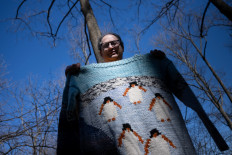 Sam Barsky, whose professional knitting led to him becoming a social media influencer, poses with a penguin sweater at the Oregon Ridge Park March 8, 2023, in Cockeysville, Maryland. Knitting clubs for men have surged in popularity once again in the United States in this age of pandemics and self-care.
