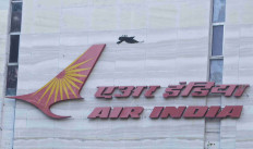 A bird flies over a logo of Air India airlines at the corporate headquarters in Mumbai, India, October 19, 2021. 