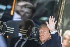 Former US president Donald Trump arrives at Trump Tower in New York on April 3, 2023. Trump arrived Monday in New York where he will surrender to unprecedented criminal charges, taking America into uncharted and potentially volatile territory as he seeks to regain the presidency. The 76-year-old Republican, the first US president ever to be criminally indicted, will be formally charged Tuesday over hush money paid to a porn star during the 2016 election campaign.
