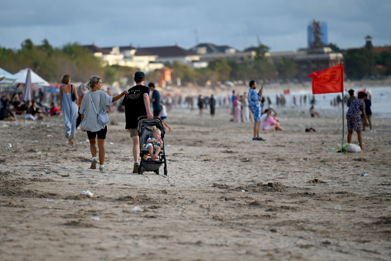 People catch the sunset on Jan. 8, 2022 at Kuta Beach, Bali.