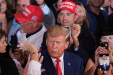 Former US President Donald Trump meets his supporters on the day of his court appearance in New York after being indicted by a Manhattan grand jury following a probe into hush money paid to porn star Stormy Daniels, in Palm Beach, Florida, US, April 4, 2023. 