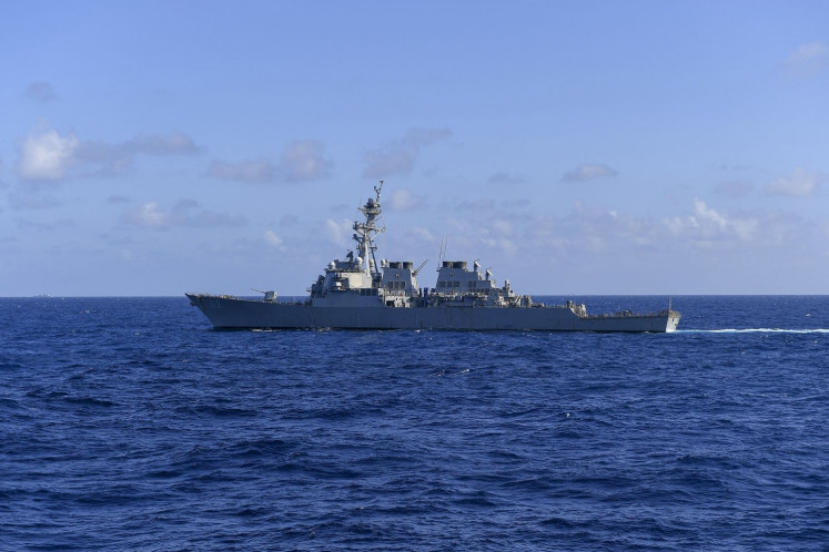 This handout photo from the US Navy taken on November 20, 2021 shows the US Navy's Arleigh Burke-class guided-missile destroyer USS Milius (DDG 69) sailing in the South China Sea. China simulated “sealing off“ Taiwan during a third day of wargames around the self-ruled island on April 10, 2023, as the United States deployed a naval destroyer into Beijing-claimed waters in a show of force.