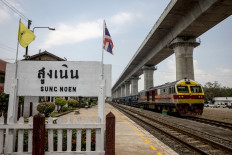 In this photo taken on March 29, 2023 a train sits below an elevated track, still under construction as part of the Thai-Chinese Bangkok-Nong Khai high-speed railway project at Sung Noen Station in Nakhon Ratchasima province. 